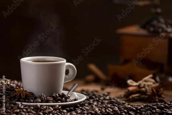 Obraz Cup of coffee with coffee beans and grinder on wooden table