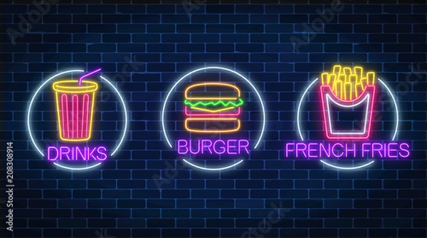 Fototapeta Set of three neon glowing signs of french fries, burger and soda drink in circle frames. Fastfood light billboard symbol