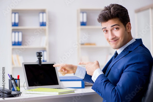 Fototapeta Young help desk operator working in office