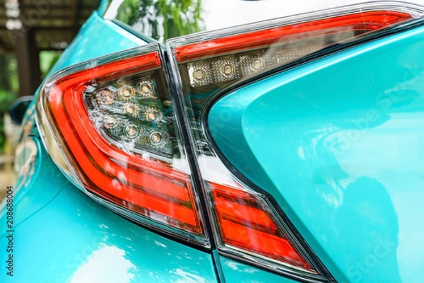 Fototapeta Detail on the rear light of a car. New led taillight by night.