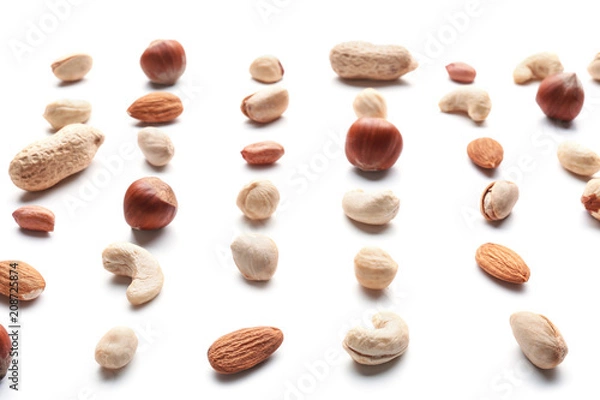 Fototapeta Different types of nuts on white background