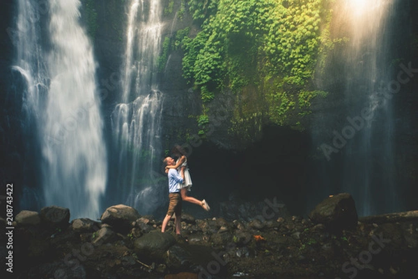 Obraz Amazing romantic view of happy couple near beautiful grand waterfall