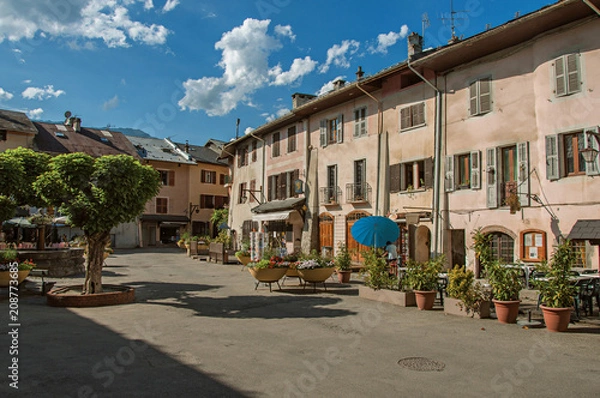 Fototapeta Square with stone building and shops in Conflans. An historical hamlet near Albertville. Located at the department of Haute-Savoie, southeastern France.