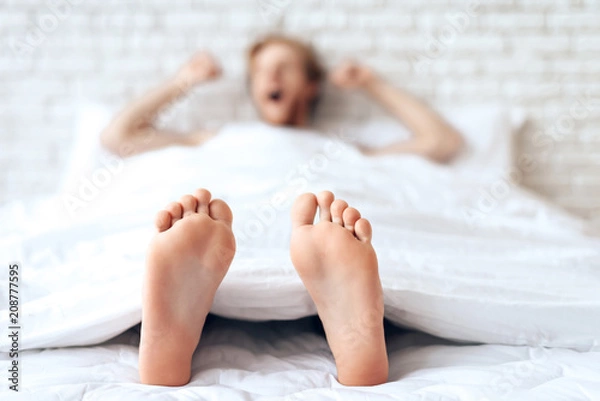 Obraz Red haired young guy is stretching, yawning