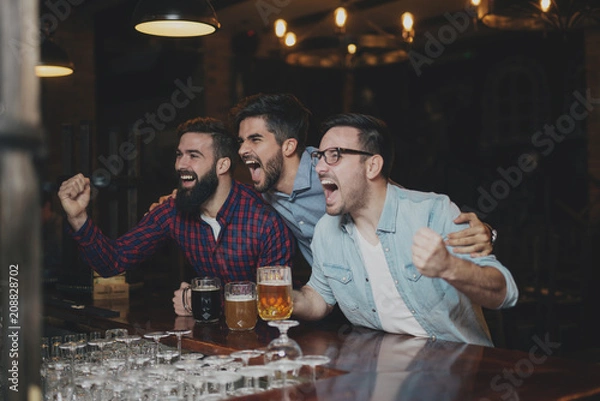 Fototapeta The guys in the pub are drinking beer