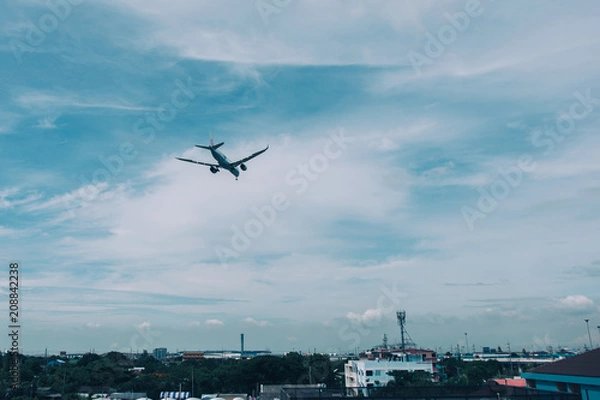 Fototapeta The plane is flying through the roof, with the sky as the background,on May 25 2018, bangkok thailand