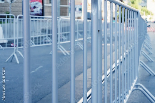 Fototapeta Portable metal grilles of light gray color for the obstruction of the territory and organization of the queue for the event