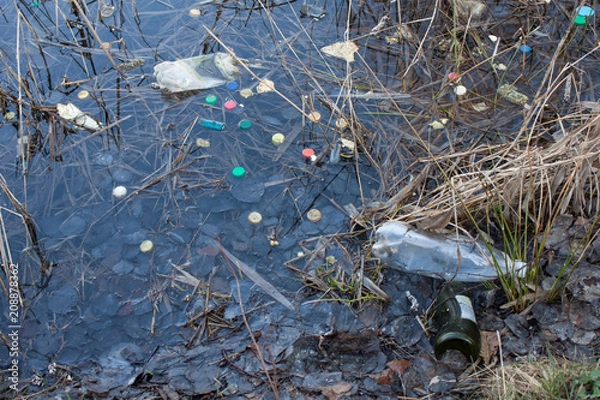 Obraz Plastic lids from bottles in the river
