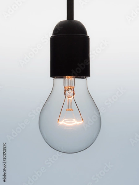 Fototapeta Light bulb shining on graduated background