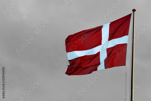 Fototapeta Danish flag in front of grey sky