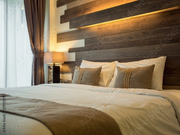 Obraz Empty double bed and lamp on side of bed in luxury and natural style bedroom is decorated with wooden boards.