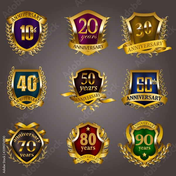 Fototapeta Set of gold anniversary badges with laurel wreaths, shield, numbers. Decorative emblem of jubilee on gray background. Filigree element, frame, border, icon, logo for web, page design in vintage style