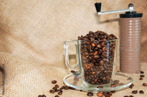 Obraz coffee beans in a cup and a hand grinder