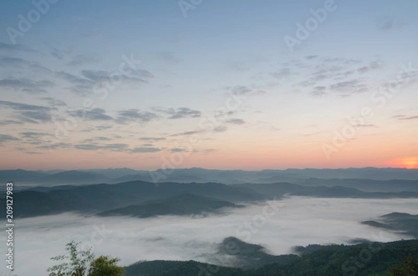 Fototapeta Sunset over mountains and fog. Start the first day of Easter day