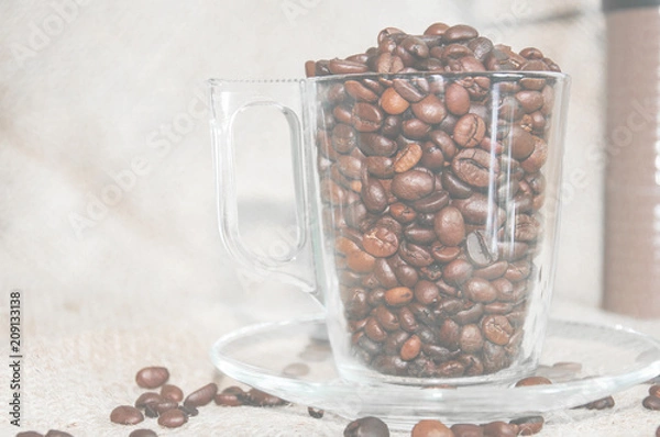 Obraz a cup of coffee on a light background, coffee beans, a cheerful morning
