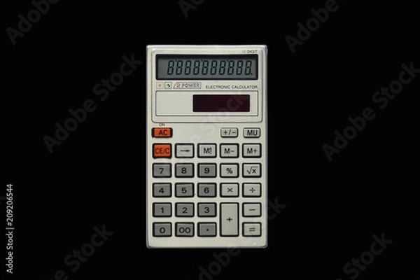 Fototapeta Used simple pocket calculator on isolated bkack background top view. Technology.