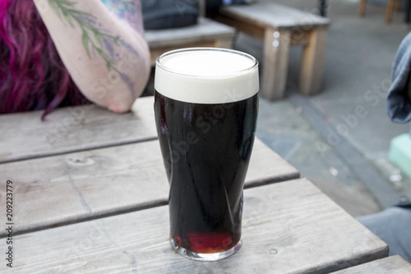 Fototapeta Full pint of Guinness with a head