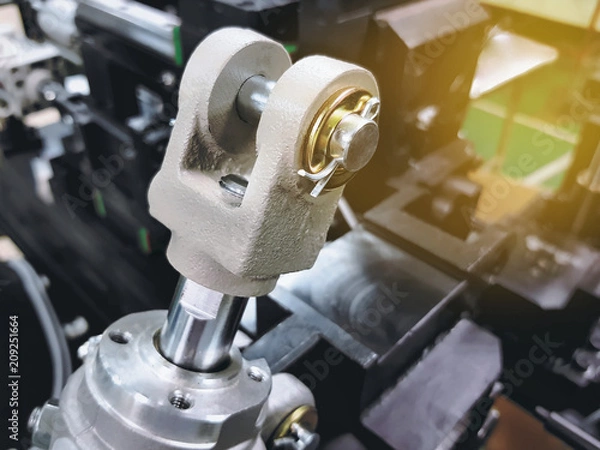 Fototapeta Close-up Rod Clevis of Pneumatic Cylinder on Blurred Machine Background