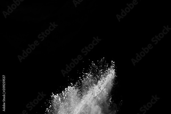 Fototapeta  Freeze motion of white dust explosion on black background. Stopping the movement of white powder on dark background. Explosive powder white on black background.