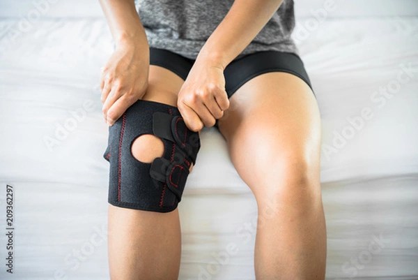 Obraz Women use knee supporter to prevent injuries.