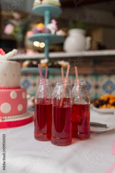 Fototapeta A festive sweet drink in a jar with a straw