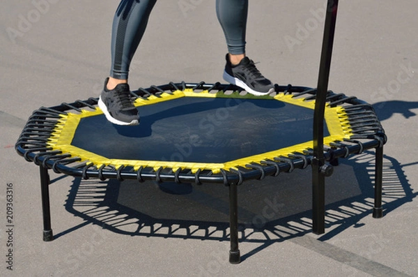 Fototapeta Jumping on an elastic trampoline.
