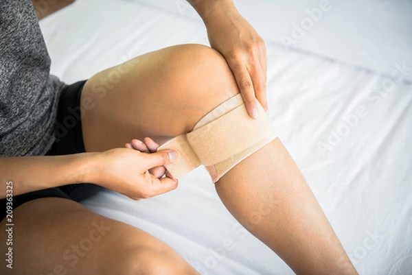 Obraz Women use knee supporter to prevent injuries.
