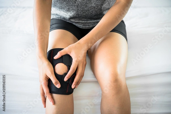 Obraz Women use knee supporter to prevent injuries.
