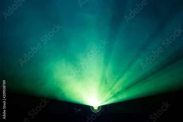 Obraz projector beautiful lighting . wide lens equipment for show presentation at night . smoke abstract background .