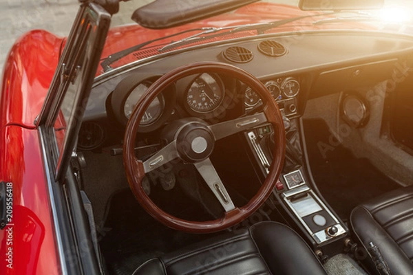 Fototapeta Retro style classic red car interior with matching dashboard