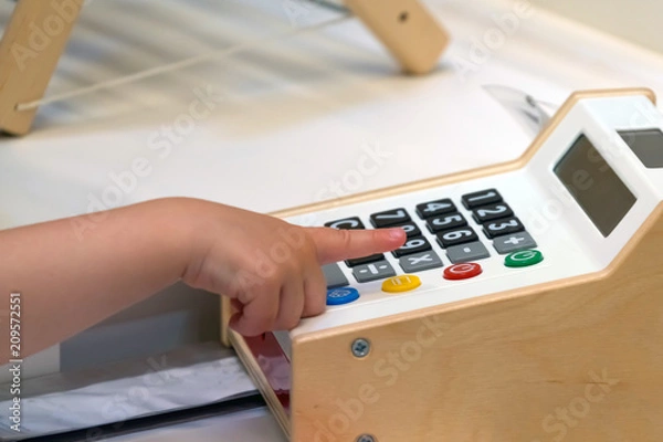Obraz Childrens calculator. The child learns to count on an electronic calculator.