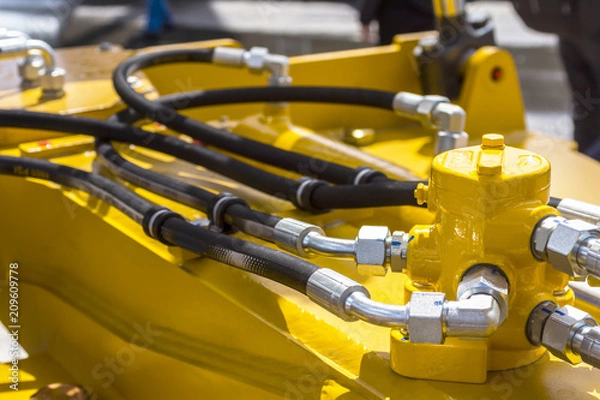 Fototapeta Close up of pipe system of hydraulic valves in agricultural machinery