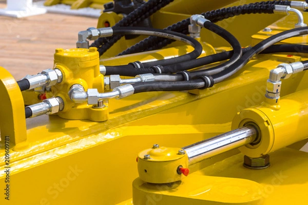 Fototapeta Close up of pipe system of hydraulic valves in agricultural machinery