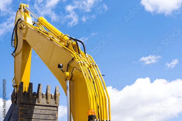 Fototapeta Hydraulic piston system for bulldozers, tractors, excavators, chrome plated cylinder shaft of yellow machine, construction heavy industry detail