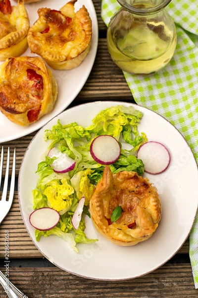 Fototapeta Flaky pastry bun filled with mozzarella cheese and tomato