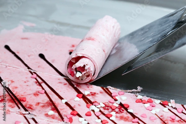 Obraz Thai roll ice cream is made by hand on the freezer. Sweet dessert made from natural berries and ingredients. The process of making food.