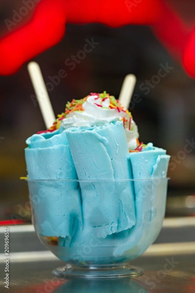 Obraz Roll ice cream is made by hand on the freezer. Sweet dessert made from natural berries and ingredients.