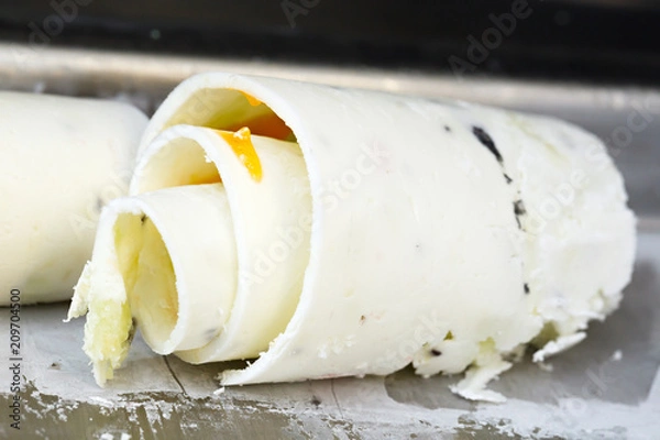 Obraz Roll ice cream is made by hand on the freezer. Sweet dessert made from natural berries and ingredients.