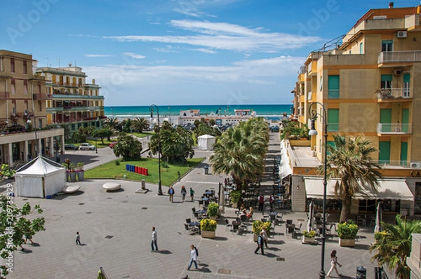 Fototapeta Overview of "Piazza Anco Marzio", the main square of Ostia, with the Mediterranean sea. The town is a seaside resort and ancient port of Rome. Located in the Lazio region. Central Italy.