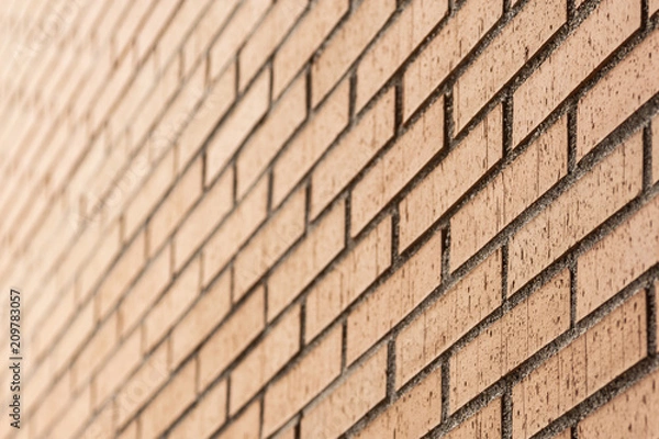 Fototapeta brown brick wall in perspective and out of focus in the background