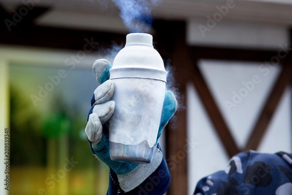 Obraz hand in glove holding a jar of liquid nitrogen