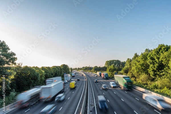 Obraz Sunset view heavy traffic moving at speed on UK motorway in England