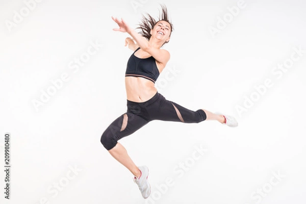 Obraz  Sporting girl is engaged in fitness on a white background