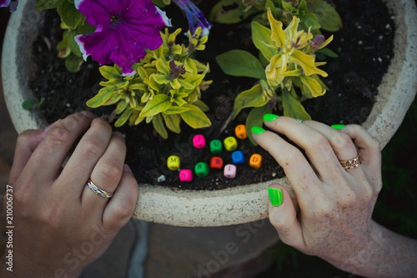 Obraz Hands of newlyweds on background wooden letters spelling just married.