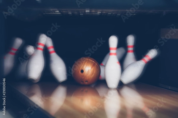 Fototapeta motion blur of bowling ball skittles on the playing field