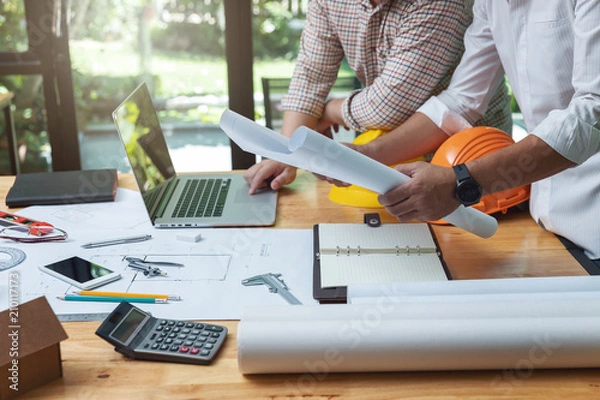 Fototapeta Engineer and Architect concept, Engineer Architects and real estate agent office team working with blueprints