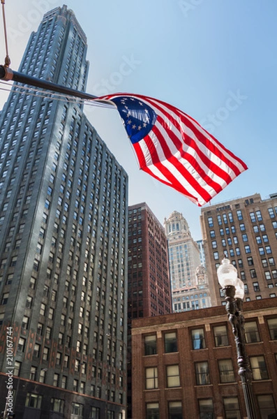 Fototapeta  US Flag in Front of Skyscrapers 