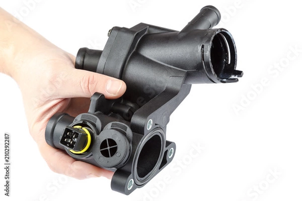 Fototapeta Body the thermostat and engine temperature sensor of car in hands