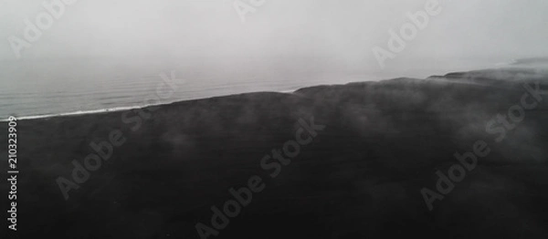 Fototapeta aerial view of black sand beach with fog in iceland