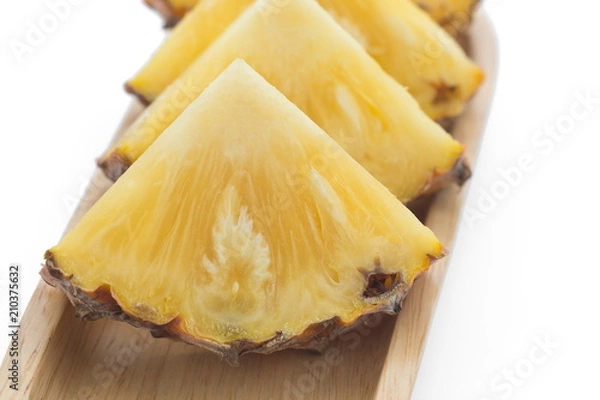 Fototapeta slice of pineapple on wooden plate.